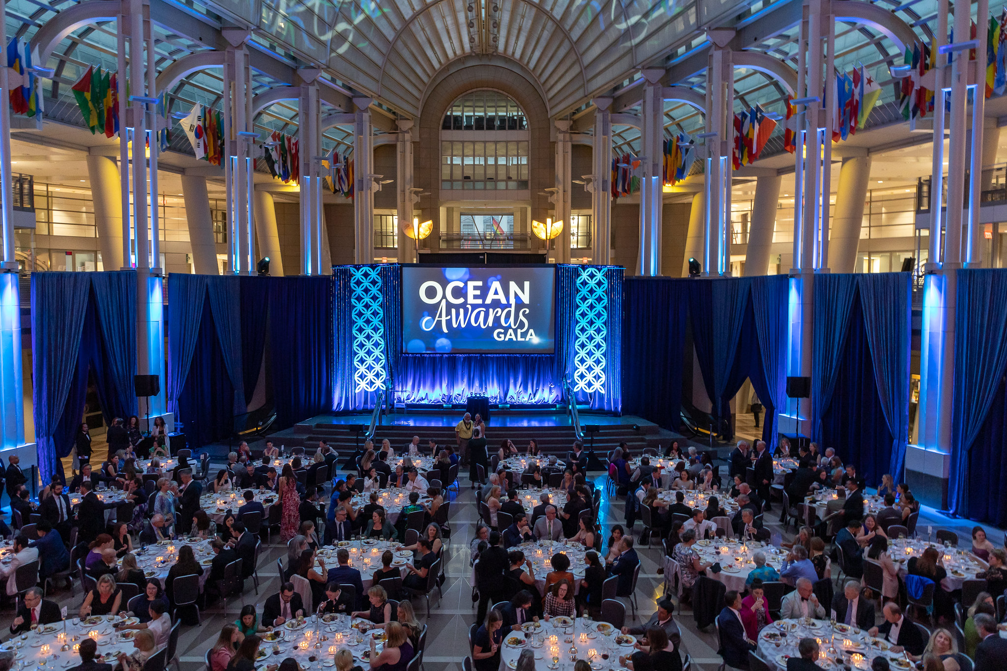 A photo of a Gala event from above showing many tables with seated people.