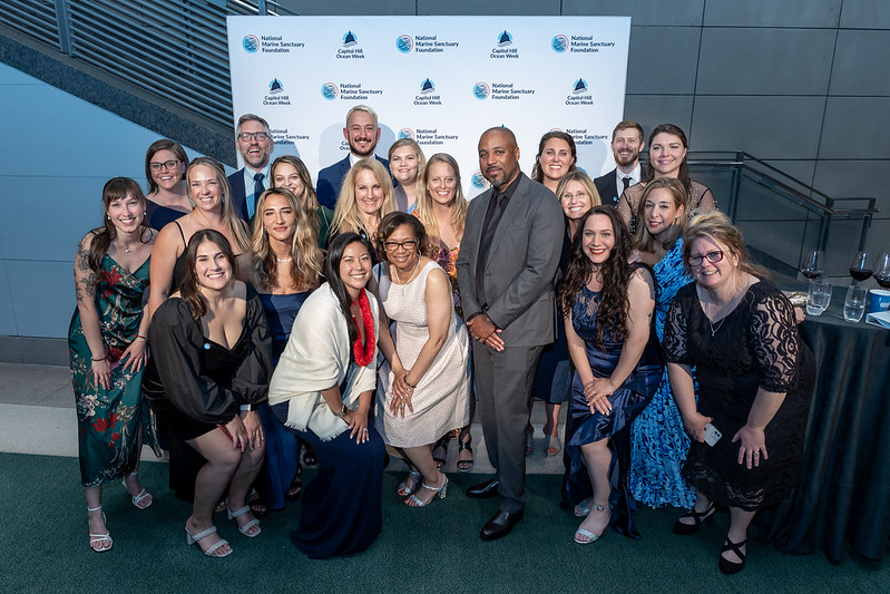 A group of people poses for a photo at a formal event.