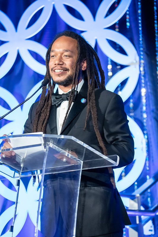 A man stands at a podium presenting.